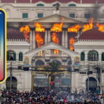 Large crowd of protesters gathered in front of historic Nepalese government building during social media ban demonstrations