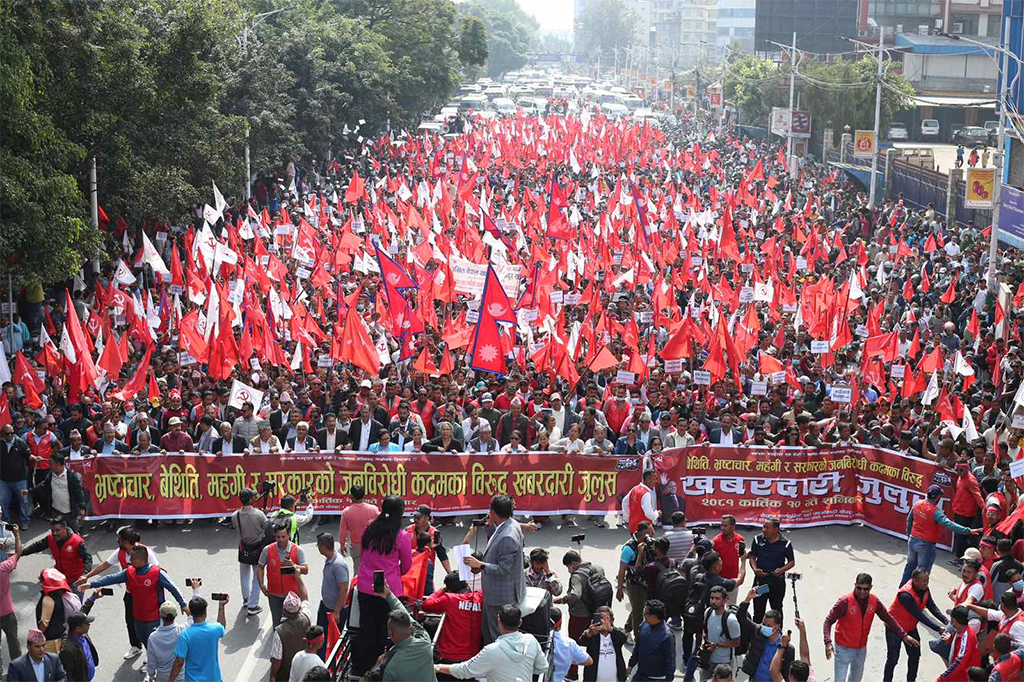 Large crowd of protesters in Kathmandu, Nepal 2025, waving red flags and demanding political change during nationwide protests.