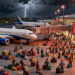 Claymation-style scene of IndiGo planes grounded at a stormy Indian airport with long passenger queues and red cancellation boards.