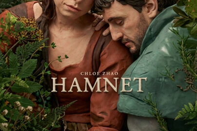 Cinematic movie poster for 'Hamnet' featuring actors Jessie Buckley and Paul Mescal in a tender, emotional embrace amidst lush green foliage. The title 'HAMNET' and 'Directed by Chloé Zhao' are centered.